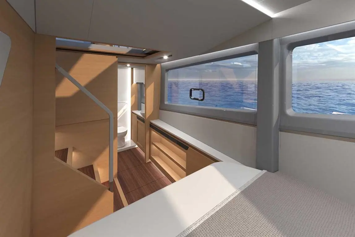 Modern yacht interior featuring wooden furnishings, a bathroom area, and large windows with a view of the ocean.